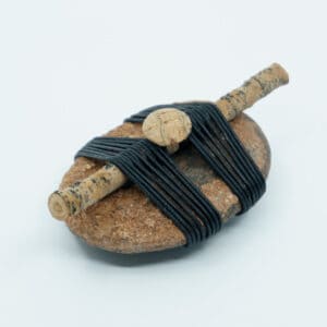 Side view of Entwined wrapped rock with stick and cork button