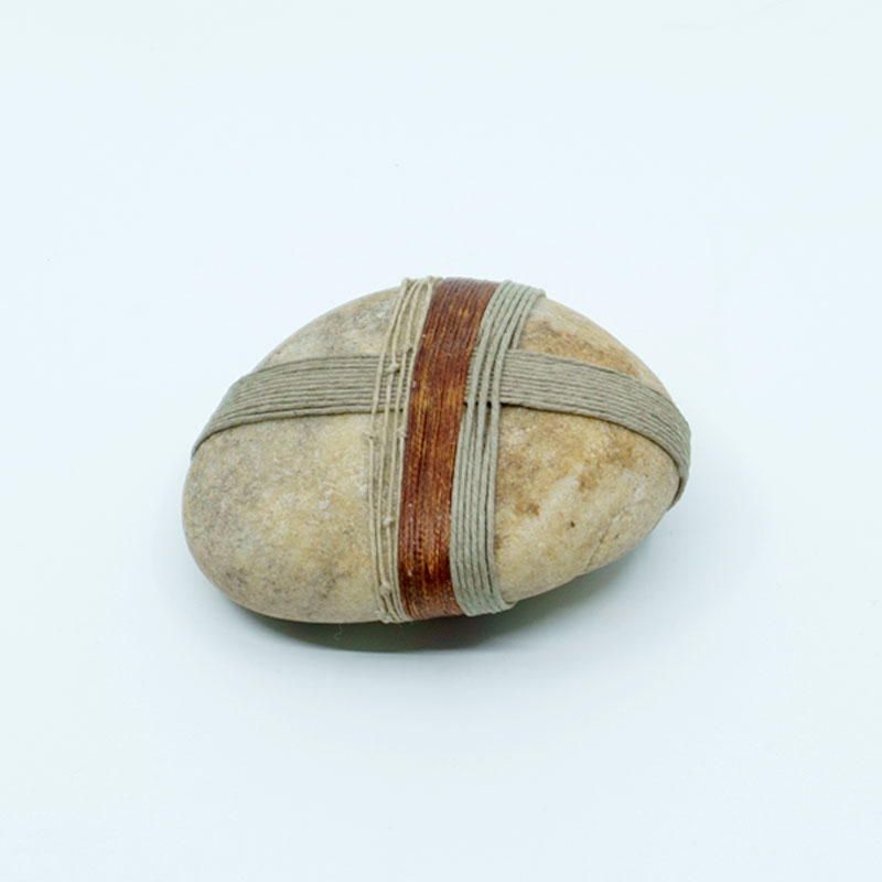 Side view of a wrapped rock called Grounding